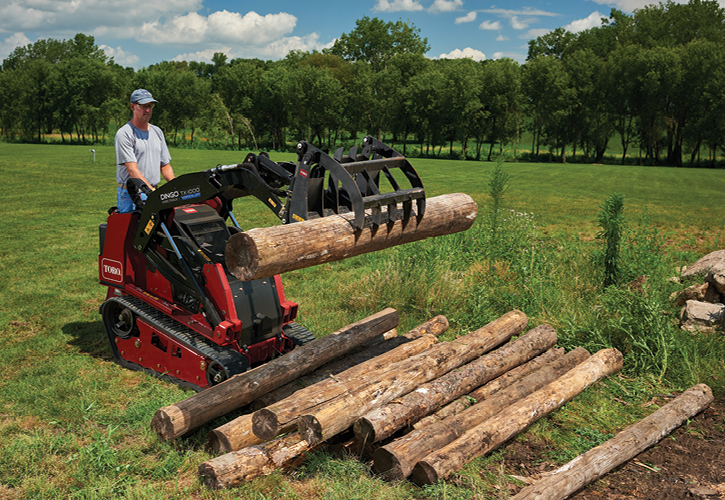 Man moving logs with a Toro Dingo