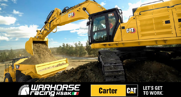 Excavator dumping dirt into a dump truck with Warhorse Racing logo at the bottom